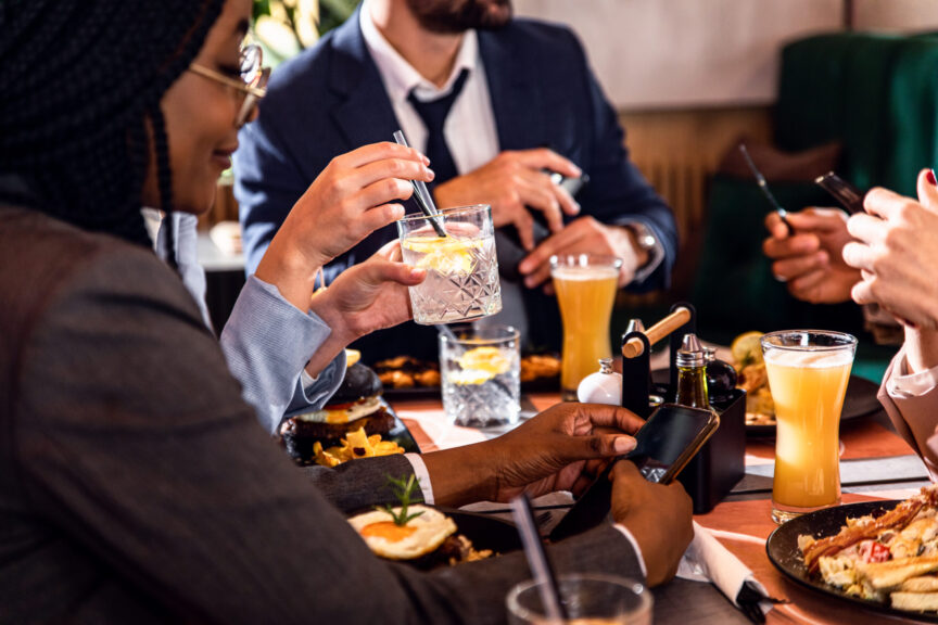 Hands of business people sitting in a restaurant at a business l OUI Laws in Massachusetts